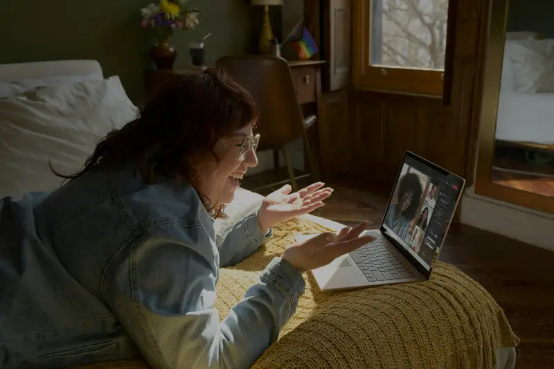 Woman greeting her counselor on a video call from home